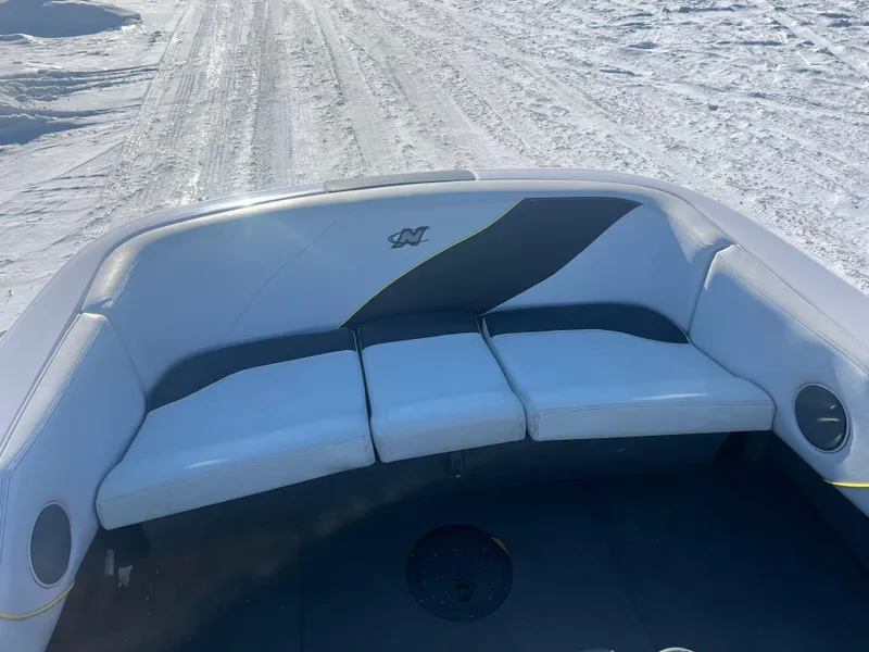 Slide: The Image of 2000 Correct Craft Ski Nautique boat interior with white seating on a snowy background. - 6