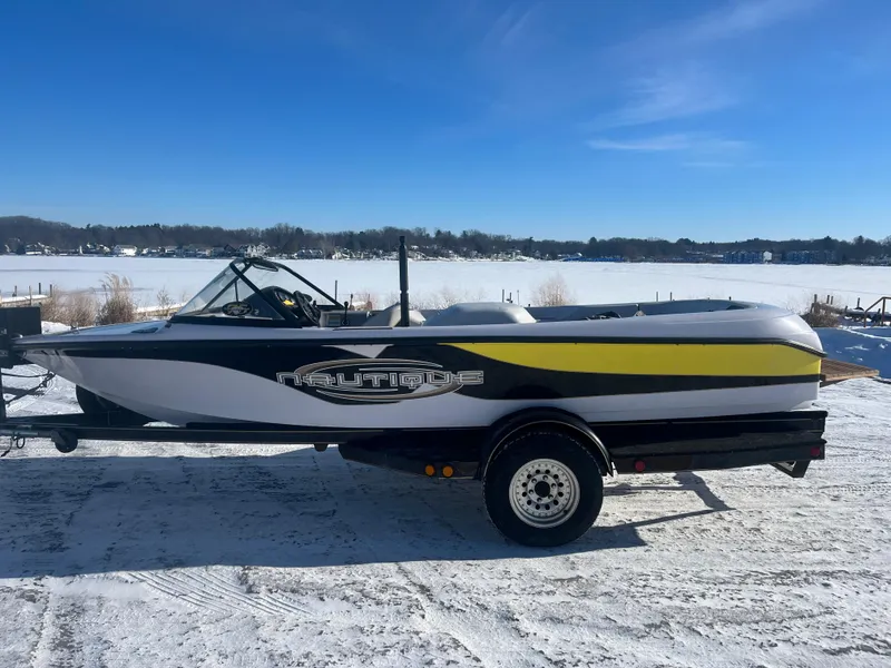 Slide: The Image of 2000 Correct Craft Ski Nautique boat on trailer, parked on snowy ground. - 8