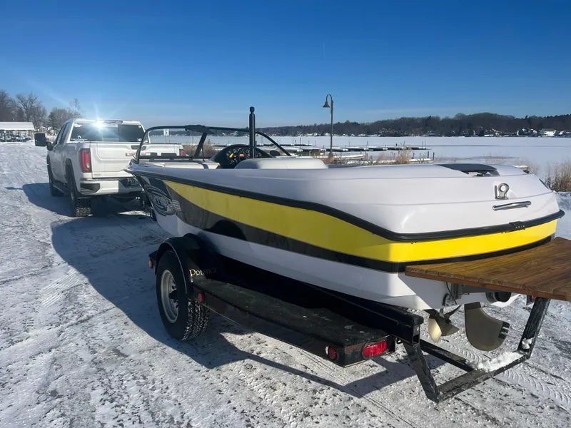 Slide: The Image of 2000 Correct Craft Ski Nautique boat on trailer, snowy landscape, clear blue sky. - 9