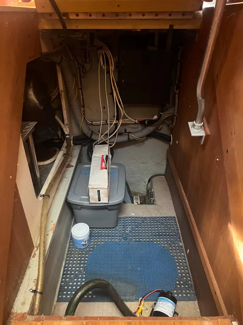 Slide: The Image of 2004 Mainship 40 FT Sedan Bridge engine room with storage and wiring. - 40