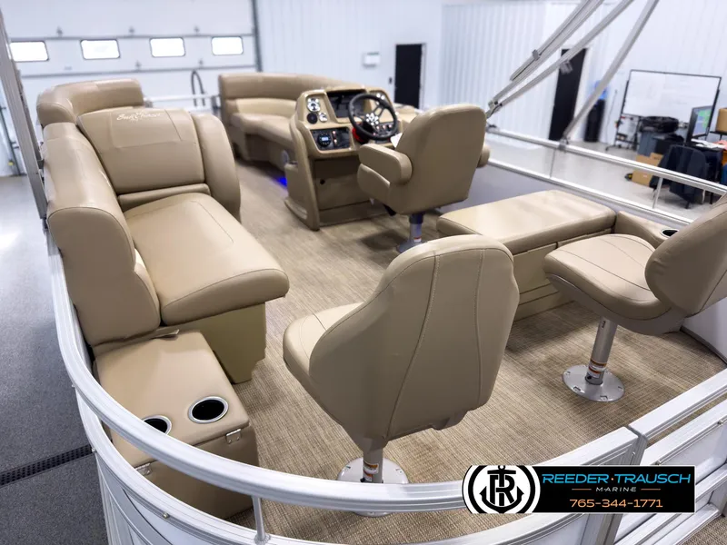 Slide: The Image of 2023 SunChaser 20 Vista Fish pontoon boat interior with beige seating and modern dashboard. - 11