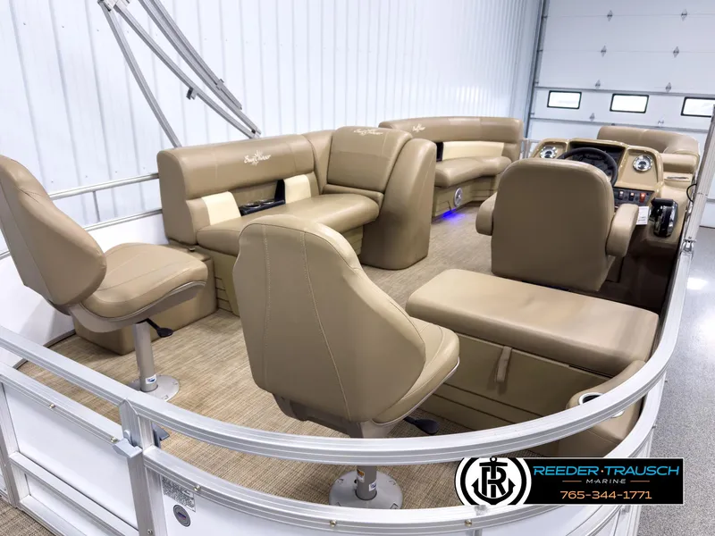Slide: The Image of 2023 SunChaser 20 Vista Fish pontoon boat interior with tan seating and modern dashboard. - 12
