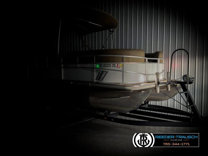 Slide: The Image of 2023 SunChaser 20 Vista Fish pontoon boat in dimly lit storage. - 4