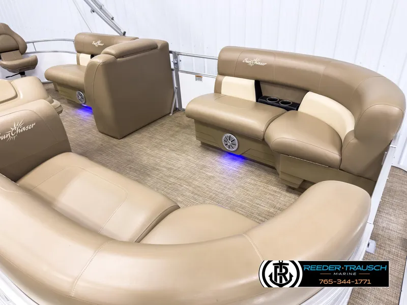 Slide: The Image of 2023 SunChaser 20 Vista Fish boat interior with beige seating and blue LED lighting. - 9