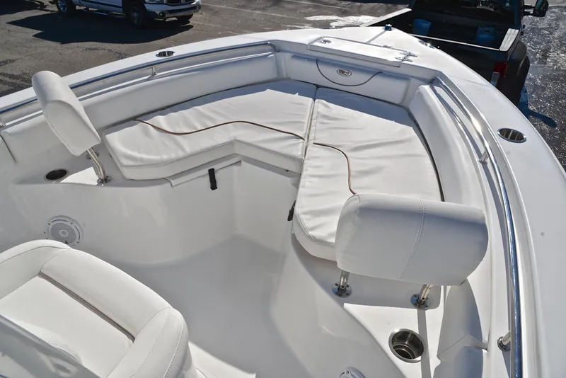 Slide: The Image of 2019 Sea Hunt 225 Ultra boat with white cushioned seating and stainless steel railings. - 22