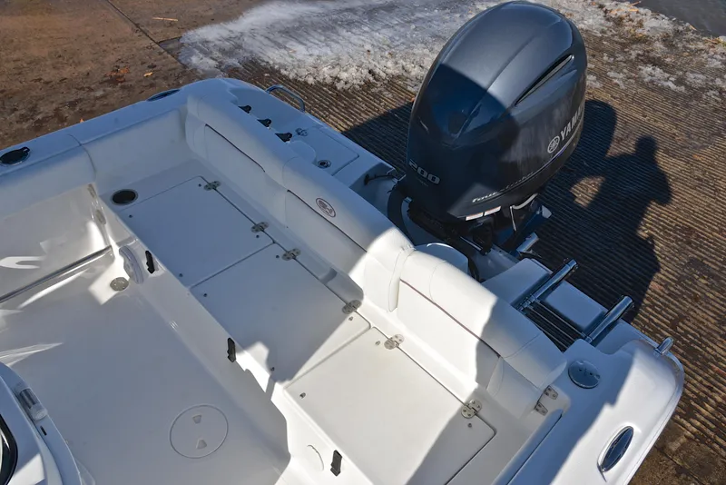 Slide: The Image of 2019 Sea Hunt 225 Ultra boat with Yamaha outboard engine, docked on a sunny day. - 25