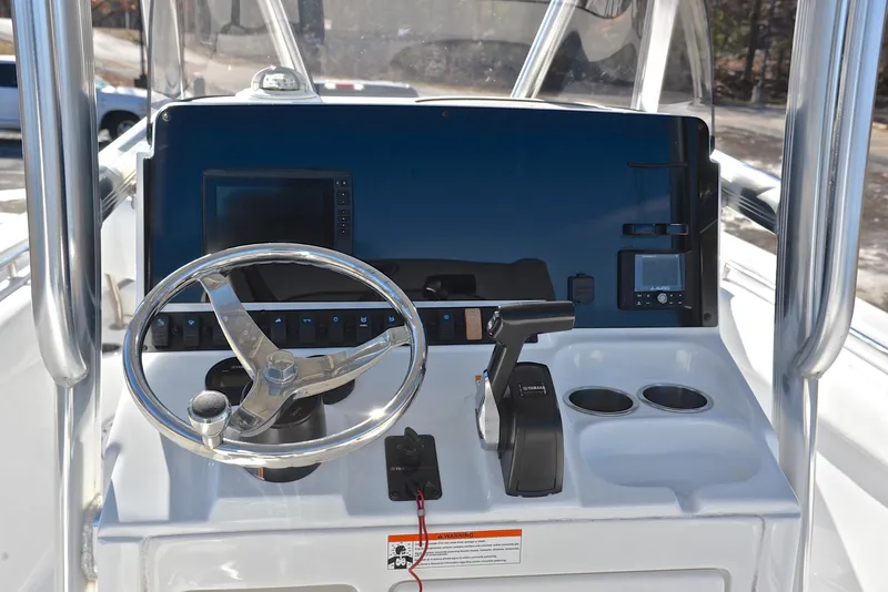 Slide: The Image of 2019 Sea Hunt 225 Ultra boat dashboard with steering wheel and controls. - 26