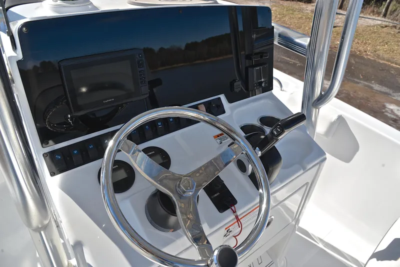 Slide: The Image of 2019 Sea Hunt 225 Ultra boat console with steering wheel and navigation system. - 27