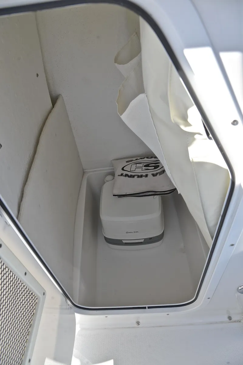 Slide: The Image of 2019 Sea Hunt 225 Ultra boat interior with portable toilet. - 28