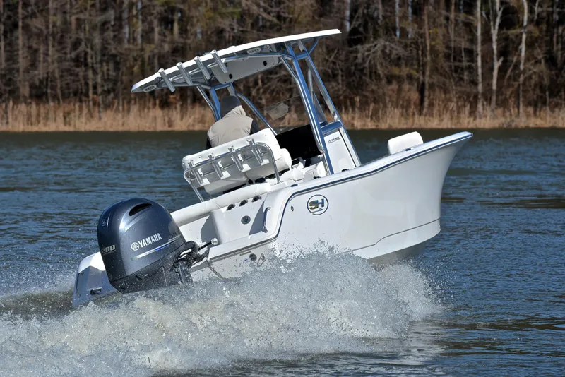 Slide: The Image of 2019 Sea Hunt 225 Ultra boat cruising on a lake with Yamaha outboard motor. - 5