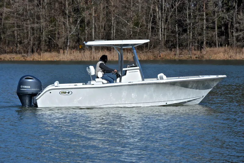 Slide: The Image of 2019 Sea Hunt 225 Ultra boat cruising on a calm lake. - 7