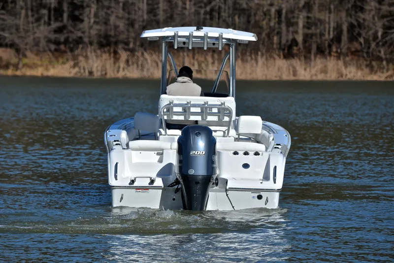 Slide: The Image of 2019 Sea Hunt 225 Ultra boat on water, rear view with outboard motor. - 8