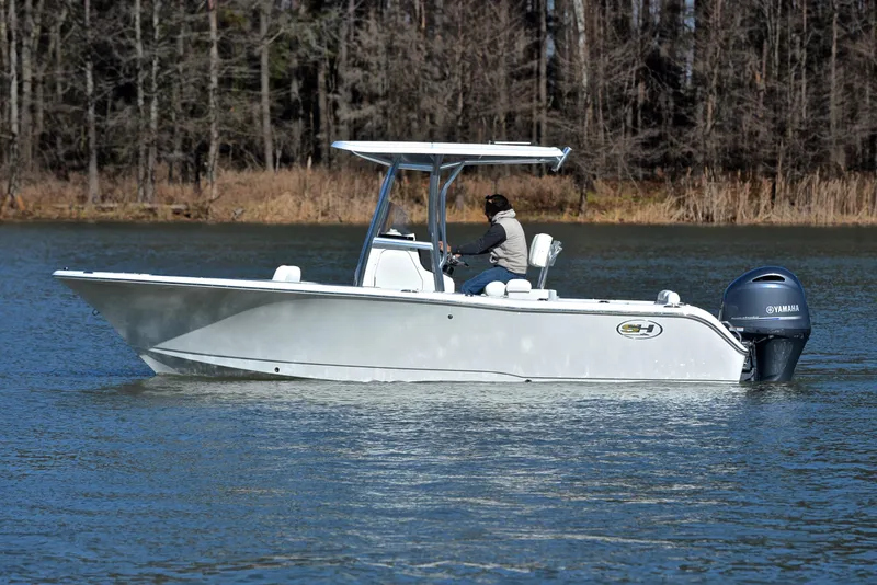 Slide: The Image of 2019 Sea Hunt 225 Ultra boat cruising on a calm lake. - 9