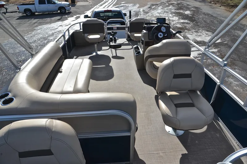 Slide: The Image of 2023 Sun Tracker Bass Buggy 18 DLX pontoon boat interior with beige seating. - 18