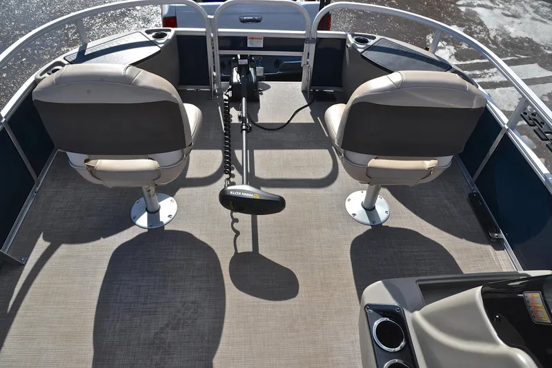 Slide: The Image of 2023 Sun Tracker Bass Buggy 18 DLX interior with two swivel seats and steering console. - 21