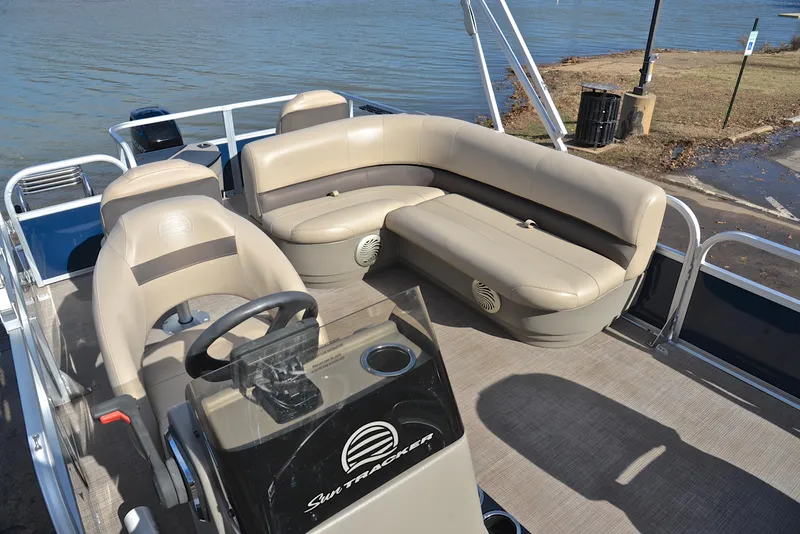 Slide: The Image of 2023 Sun Tracker Bass Buggy 18 DLX pontoon boat with beige seating. - 23
