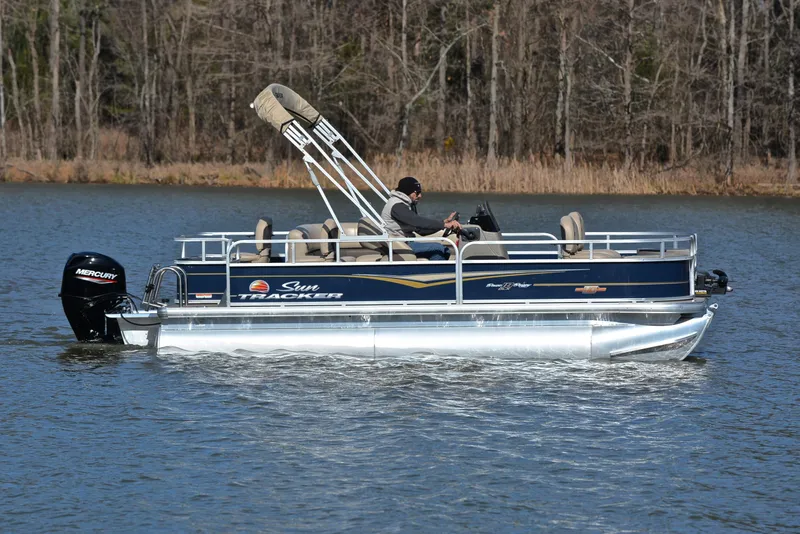 Slide: The Image of 2023 Sun Tracker Bass Buggy 18 DLX pontoon boat on a lake. - 6