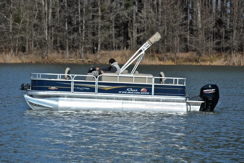 Slide: The Image of 2023 Sun Tracker Bass Buggy 18 DLX pontoon boat on a lake. - 8