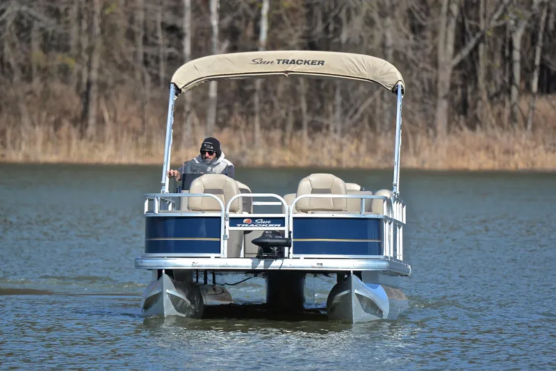 Slide: The Image of 2023 Sun Tracker Bass Buggy 18 DLX pontoon boat on a lake. - 9