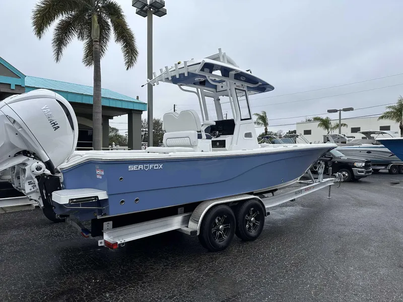 Slide: The Image of 2025 Sea Fox 282 Hybrid LT boat on trailer, displayed outdoors. - 0