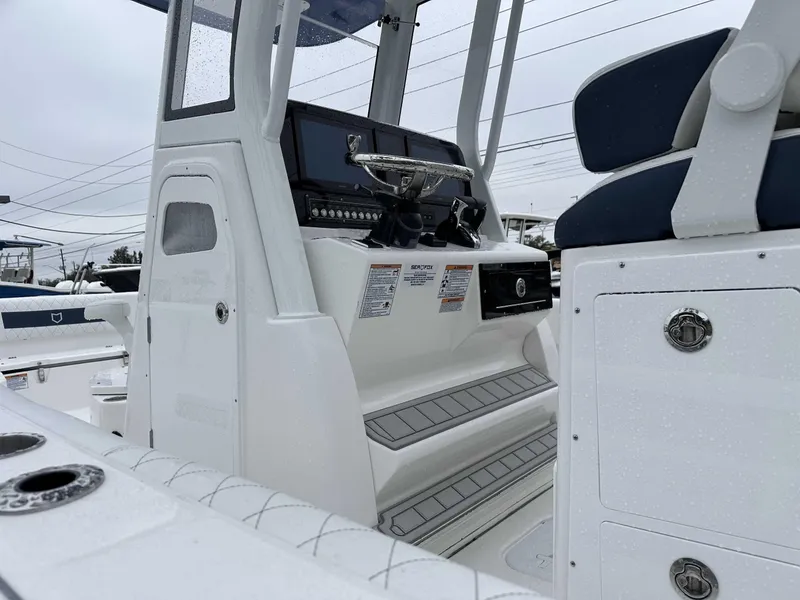 Slide: The Image of 2025 Sea Fox 282 Hybrid LT boat interior with helm and seating details. - 11