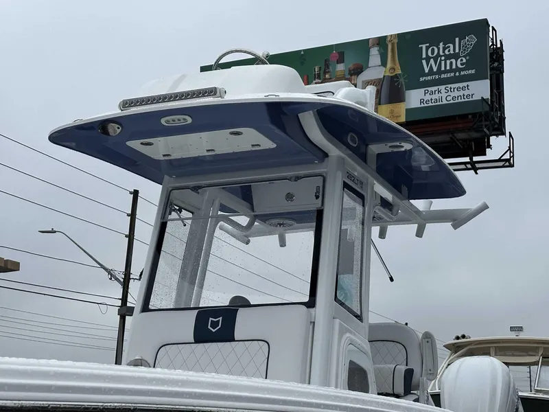 Slide: The Image of 2025 Sea Fox 282 Hybrid LT boat with a Total Wine billboard in the background. - 2