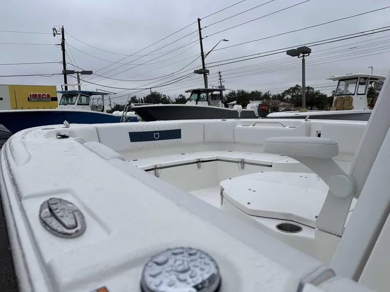 Slide: The Image of 2025 Sea Fox 282 Hybrid LT boat, white interior, parked outdoors on a cloudy day. - 7