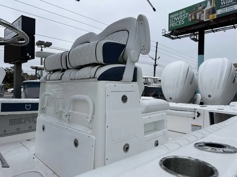 Slide: The Image of 2025 Sea Fox 282 Hybrid LT boat interior with cushioned seating and dual outboard engines. - 8