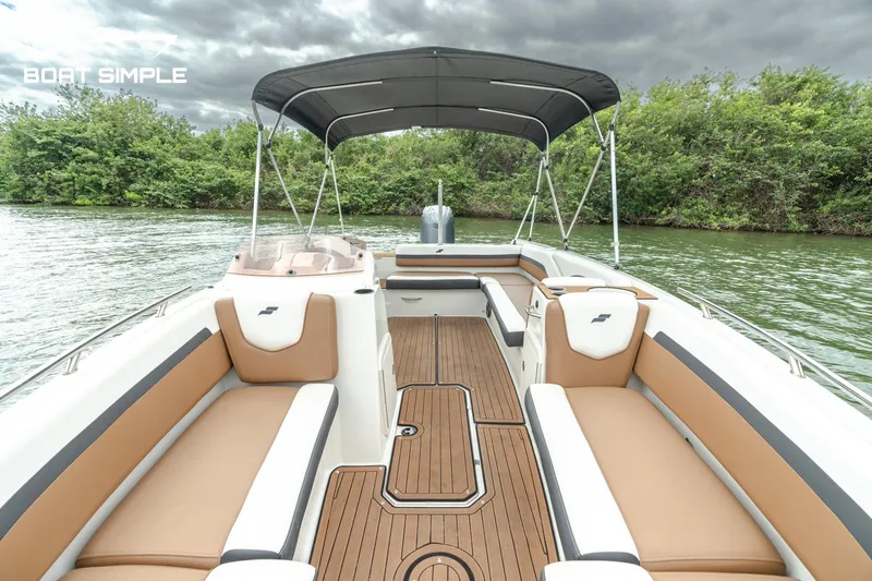Slide: The Image of 2024 Starcraft SVX 211 OB boat with spacious seating and canopy on a serene lake. - 9