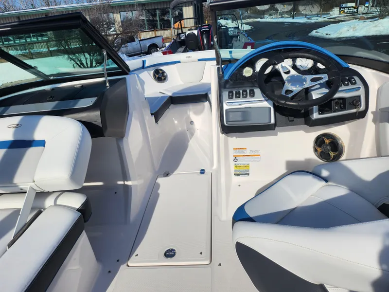 Slide: The Image of 2016 Regal 2000 ESX Bowrider interior with white seating and modern dashboard. - 11