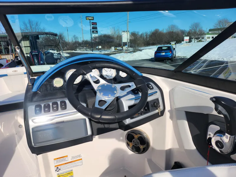 Slide: The Image of 2016 Regal 2000 ESX Bowrider dashboard with steering wheel and controls. - 12