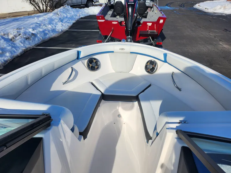 Slide: The Image of 2016 Regal 2000 ESX Bowrider boat interior with white seating and blue accents. - 16