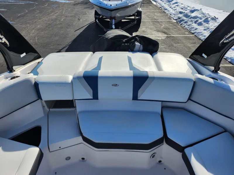 Slide: The Image of 2016 Regal 2000 ESX Bowrider interior with white and blue seating, parked on snowy pavement. - 20