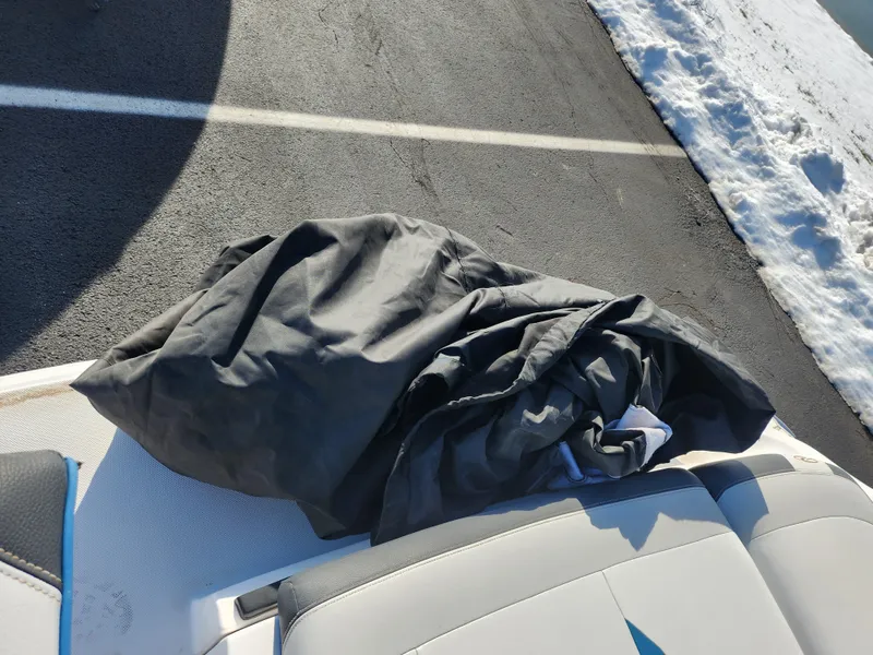 Slide: The Image of 2016 Regal 2000 ESX Bowrider with cover on seat, parked on snowy pavement. - 22