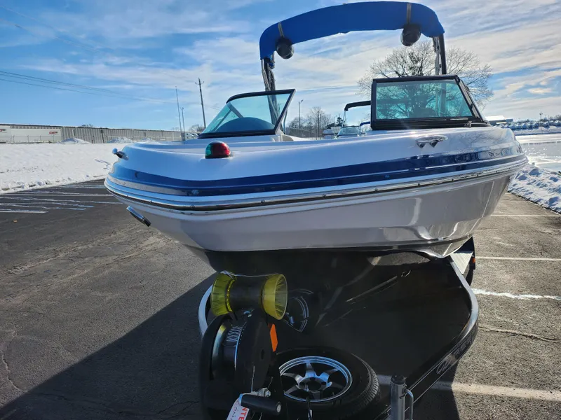Slide: The Image of 2016 Regal 2000 ESX Bowrider boat on trailer, parked in snowy lot. - 6