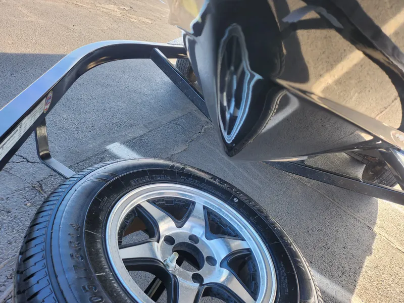 Slide: The Image of 2016 Regal 2000 ESX Bowrider on trailer with spare tire, close-up view. - 7