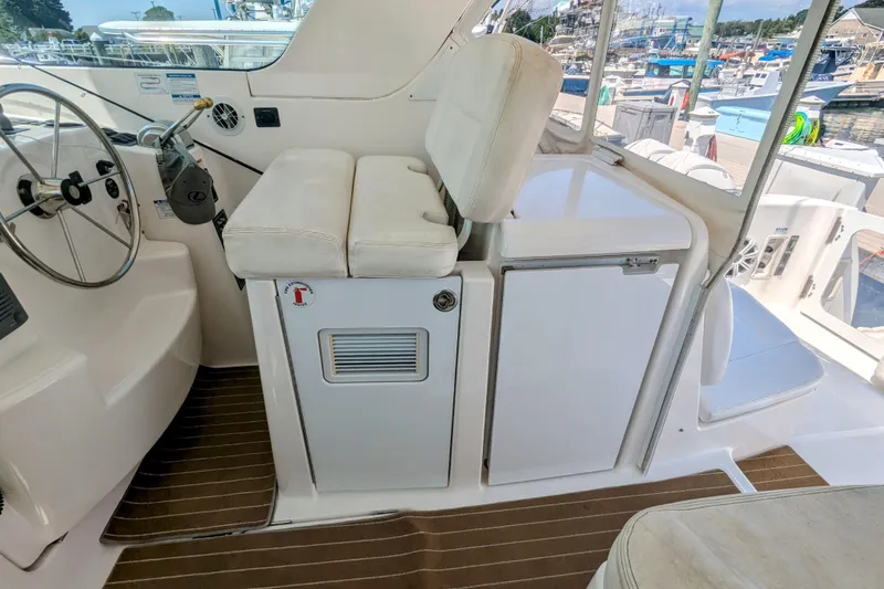 Slide: The Image of 2007 Tiara Yachts 3600 Sovran helm area with steering wheel and seating. - 11