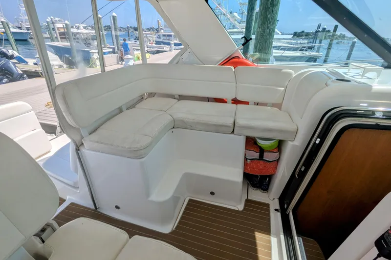 Slide: The Image of 2007 Tiara Yachts 3600 Sovran interior with white seating and marina view. - 13