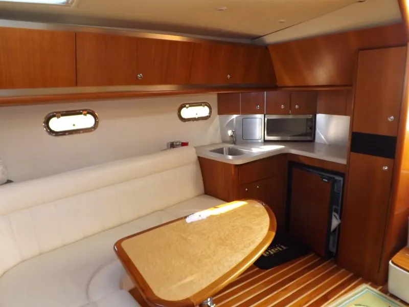 Slide: The Image of 2007 Tiara Yachts 3600 Sovran interior with kitchenette and seating area. - 22