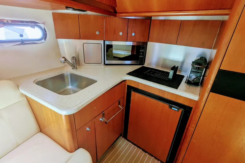 Slide: The Image of 2007 Tiara Yachts 3600 Sovran galley with sink, microwave, and compact fridge. - 24