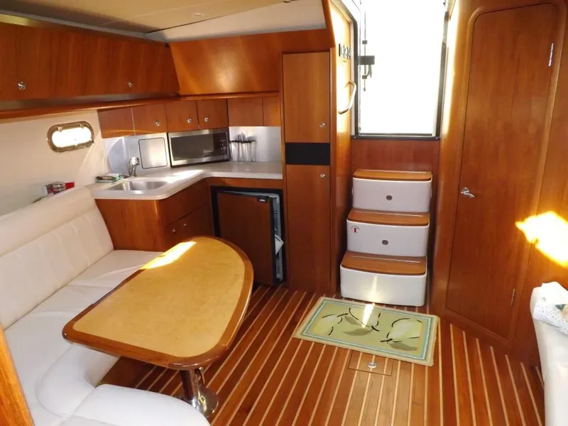 Slide: The Image of Interior of 2007 Tiara Yachts 3600 Sovran with wood finish and compact kitchen. - 26
