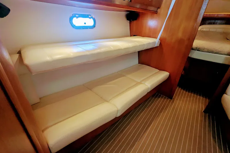Slide: The Image of 2007 Tiara Yachts 3600 Sovran interior with bunk beds and wooden finish. - 29