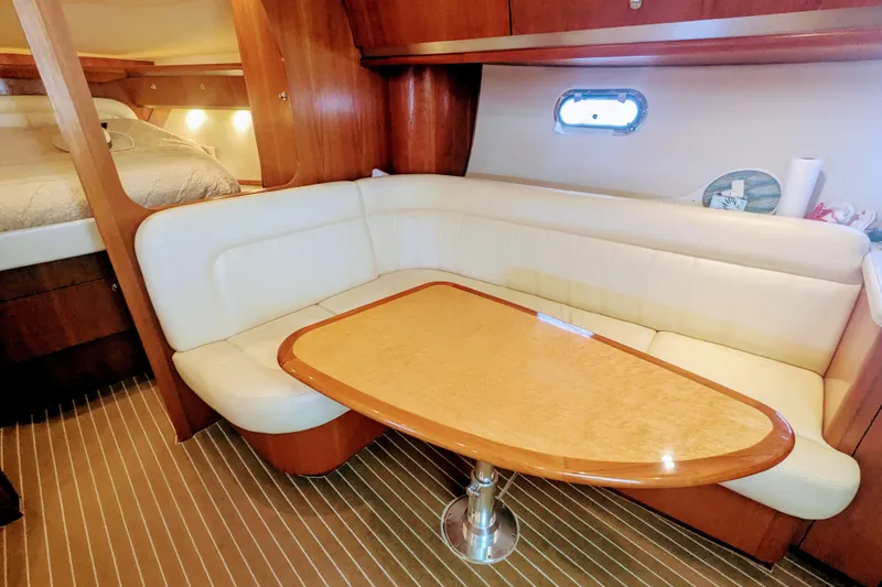 Slide: The Image of 2007 Tiara Yachts 3600 Sovran interior with cozy seating and elegant wooden table. - 30