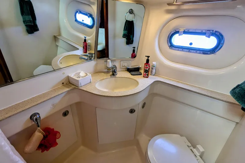 Slide: The Image of 2007 Tiara Yachts 3600 Sovran bathroom with sink, mirror, and porthole window. - 36