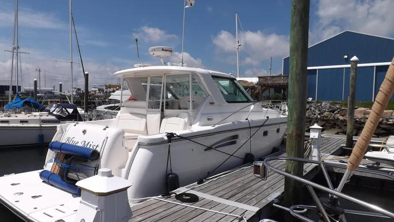 Slide: The Image of 2007 Tiara Yachts 3600 Sovran docked at marina, clear sky, blue building in background. - 6