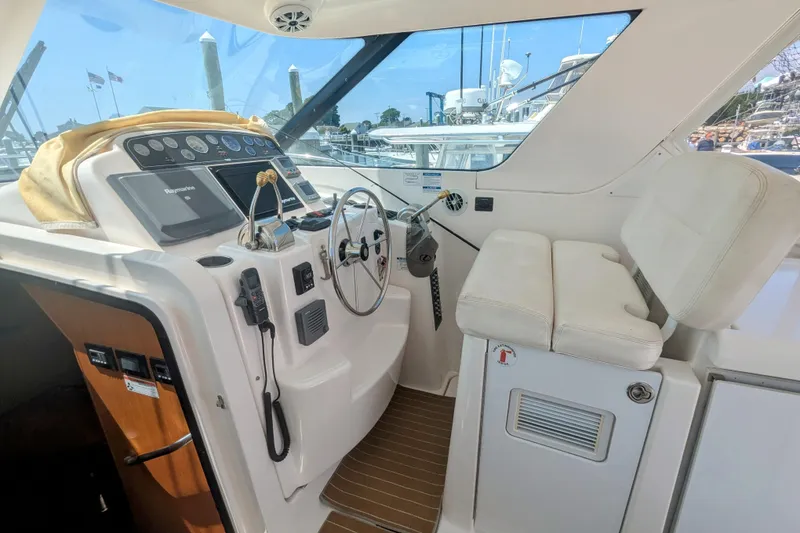 Slide: The Image of 2007 Tiara Yachts 3600 Sovran helm with steering wheel and navigation controls. - 9