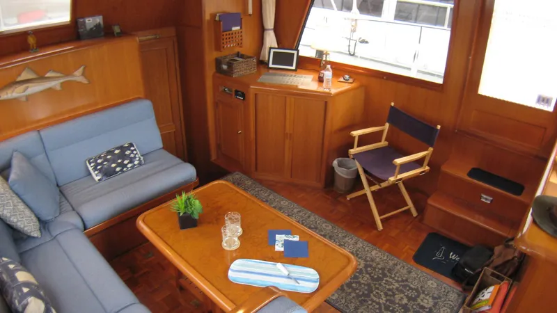 Slide: The Image of Interior of 2003 Ocean Alexander 423 Classicco yacht with cozy seating and wooden decor. - 18