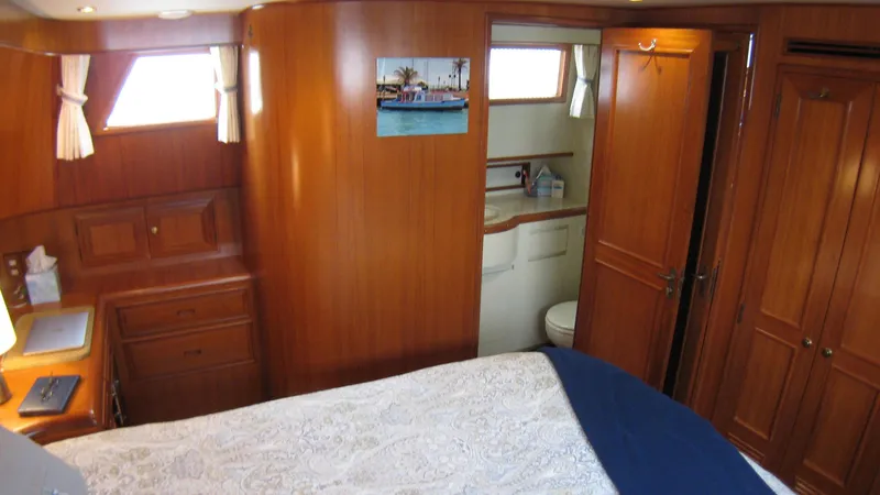 Slide: The Image of Interior of 2003 Ocean Alexander 423 Classicco yacht with wooden cabinetry and cozy bedroom. - 26
