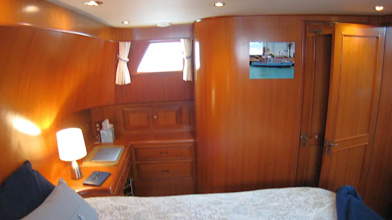 Slide: The Image of Luxurious cabin interior of 2003 Ocean Alexander 423 Classicco yacht with wooden furnishings. - 29