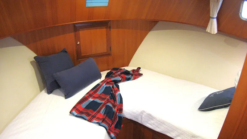 Slide: The Image of Cozy cabin interior of 2003 Ocean Alexander 423 Classicco with bed and plaid blanket. - 32